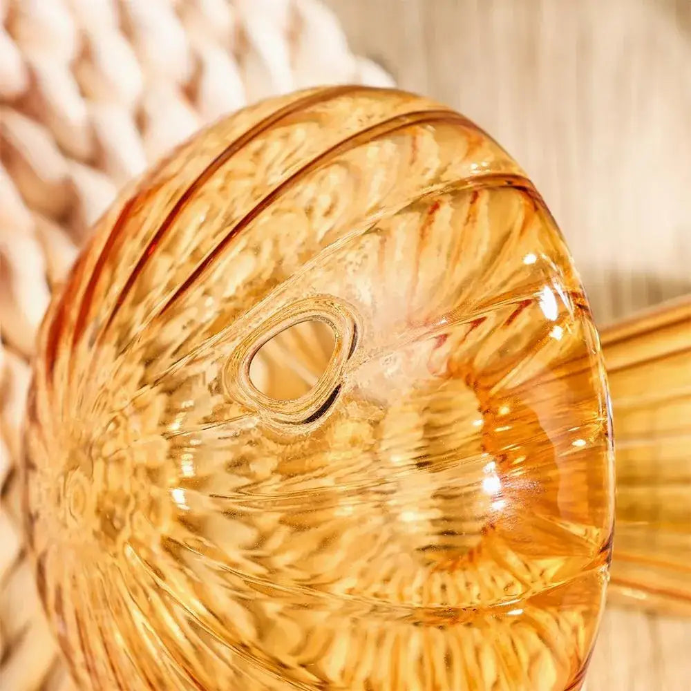 Amber-colored glass vase with intricate swirling patterns and central opening for hydroponic flower home decor by decorbites