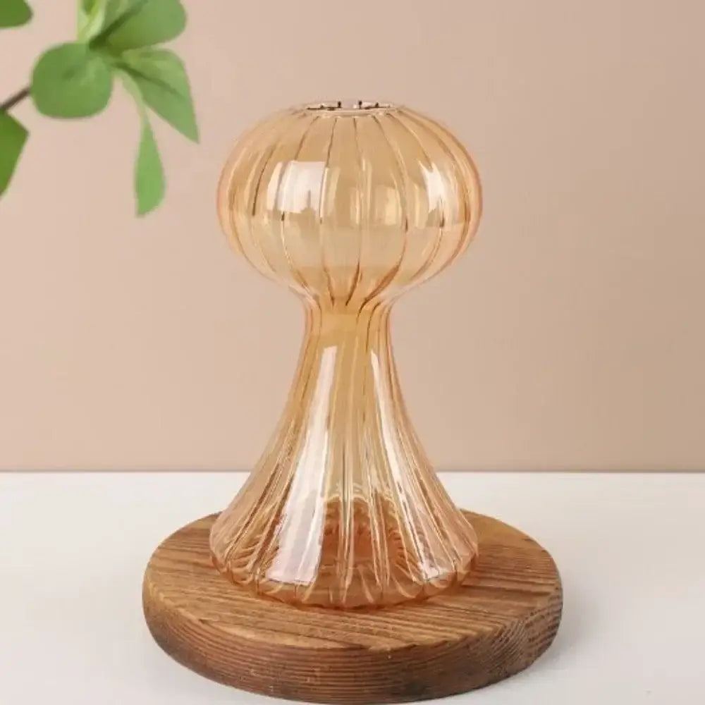 Decorbites™ glass hydroponic flower vase in translucent amber with vertical ridges on a round wooden base for home decor