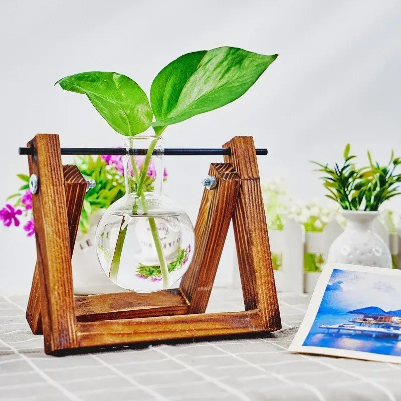 DecorBites™ glass planter propagation station with clear glass vase green leaves and rustic wooden a-frame stand