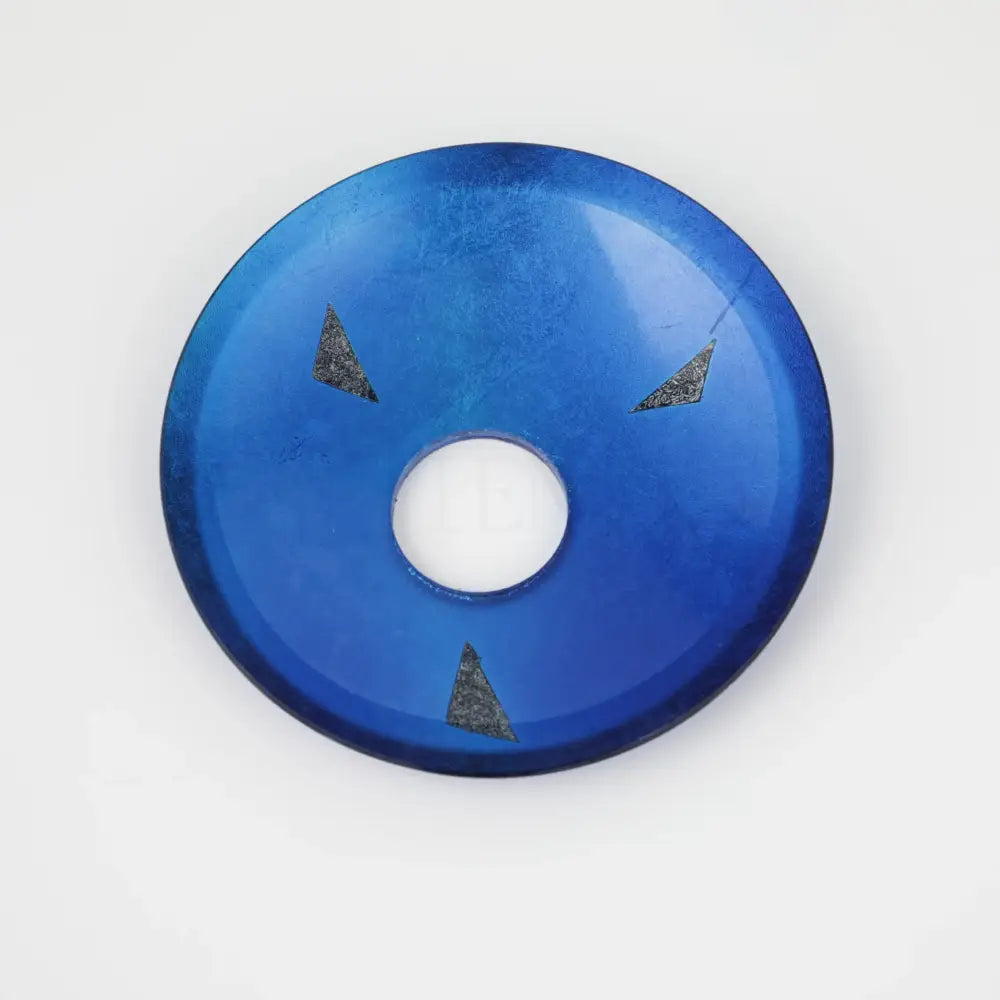 A vibrant blue glass rocker handle with a central hole and three dark triangular inlays for a basin faucet