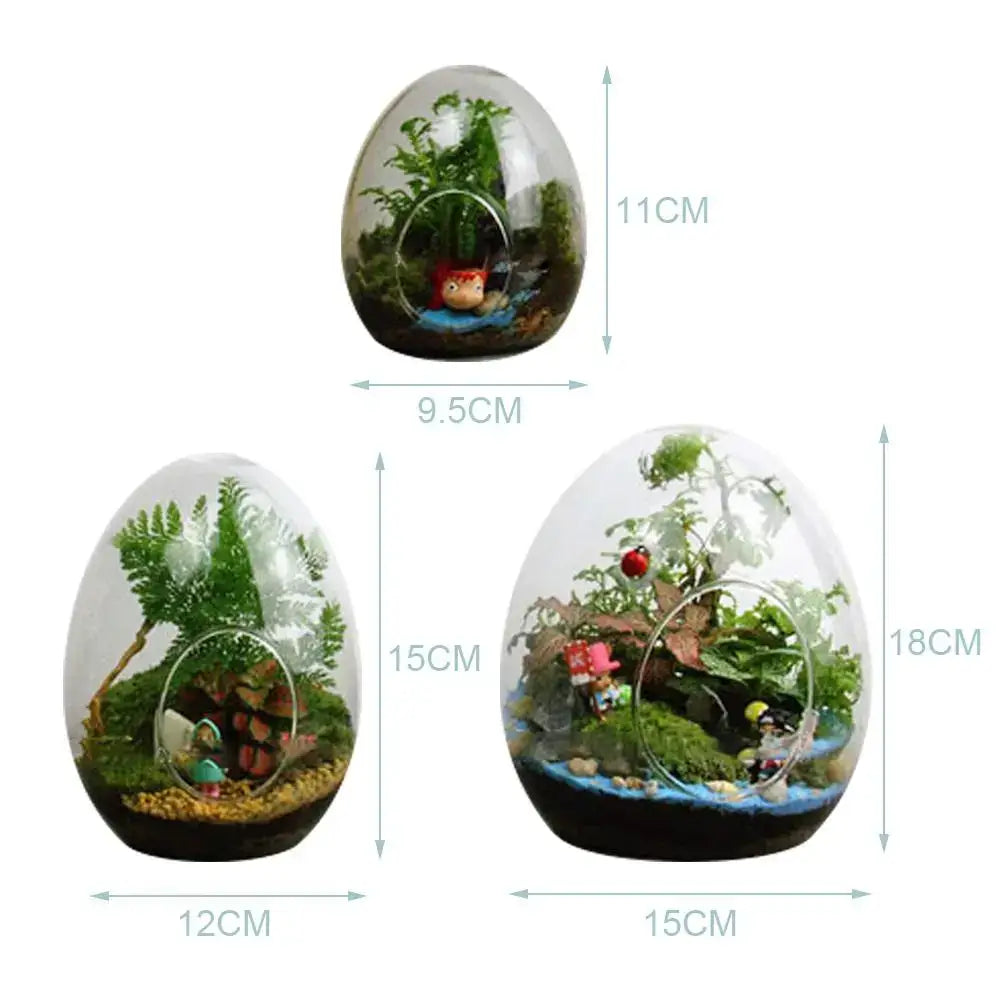 DecorBites™ high quality glass egg-shaped terrarium with miniature greenery and decorative figurines inside