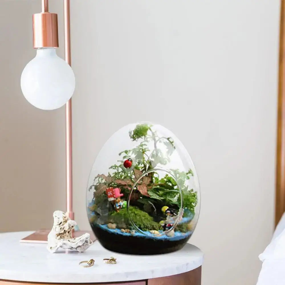 Decorbites™ egg-shaped terrarium with lush green plants and figurines in high quality glass for elegant decor