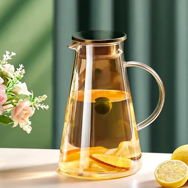 Decorbites™ glass tea jug with gold-toned lid and handle filled with citrus-infused liquid in water kettle set