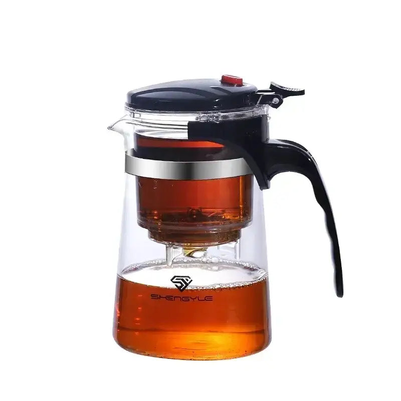 Clear glass tea kettle with black lid handle silver band and shengyle branding for brewing tea by DecorBites glass tea