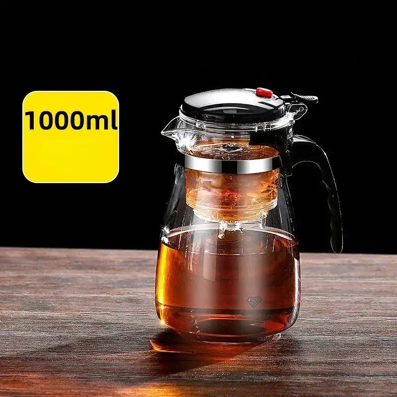 Decorbites glass tea kettle with clear glass body, black handle and lid, and stainless steel infuser basket inside