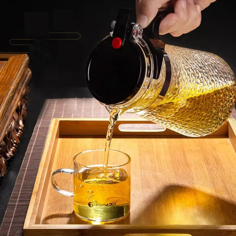 Clear glass decorbites glass tea maker with hammered surface and black lid with red button for brewing perfect tea