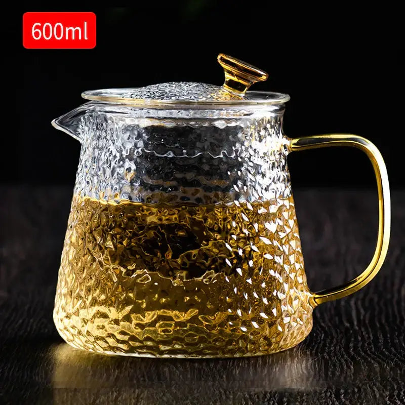 DecorBites™ glass tea pot set with clear hammered glass and gold-toned handle brewing amber tea