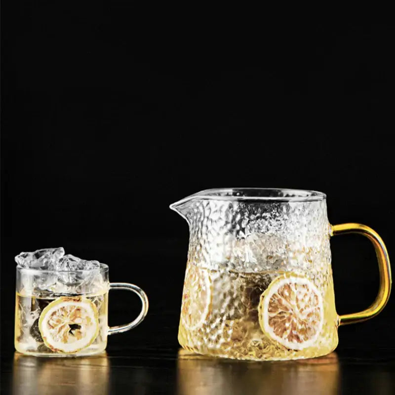 DecorBites glass tea pot set with textured clear glass, gold-toned handle, filled with lemon tea for brewing