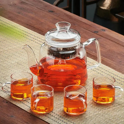 Decorbites™ glass tea pot set with high quality filterable clear glass kettle filled with amber tea and four matching cups