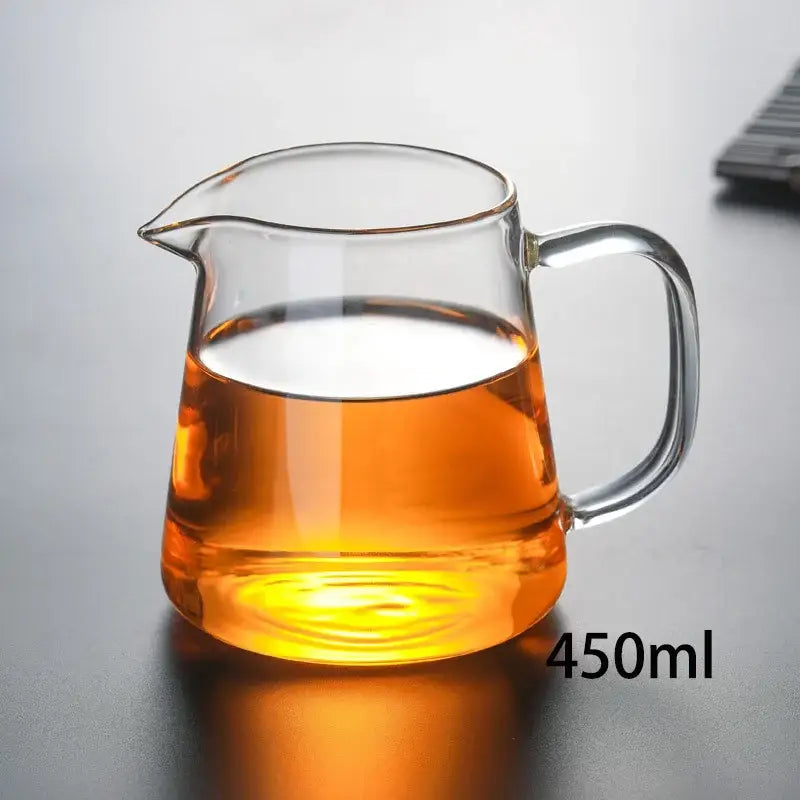 Clear glass heat-resistant teapot filled with amber tea from decorbites™ tea pot set with infuser for puer brewing