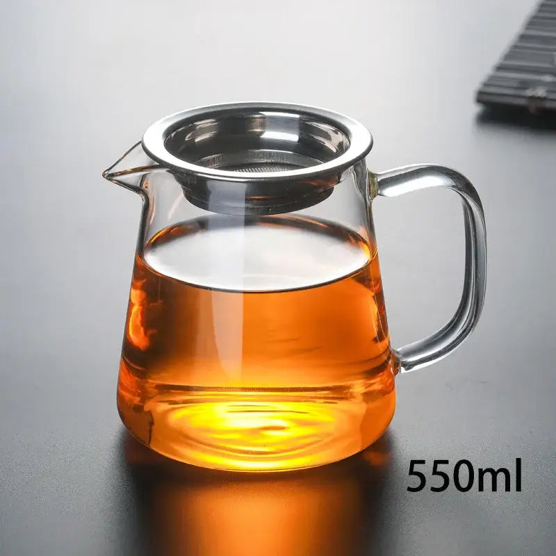 Clear glass tea pot set with stainless steel infuser holding amber tea for heat-resistant puer tea brewing by decorbites
