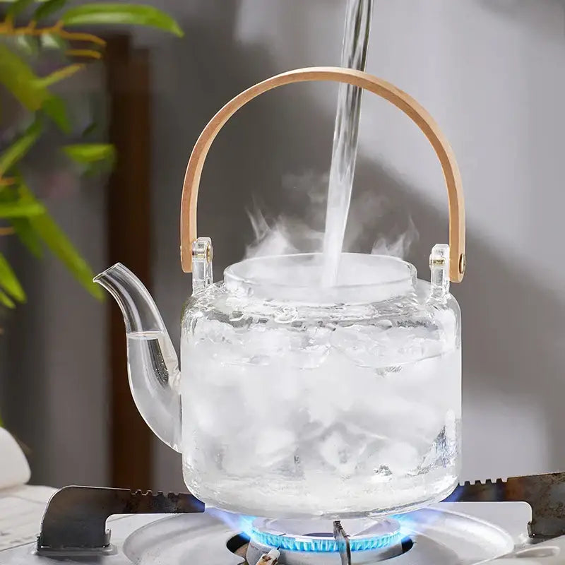 Clear glass tea pot with bamboo handle and double filter liner from decorbites glass tea pot filled with ice cubes and hot water