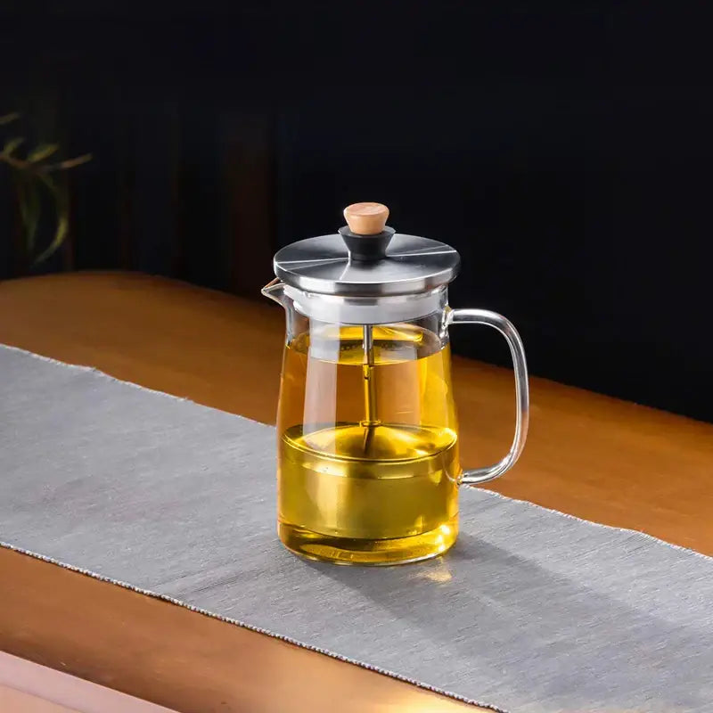 DecorBites glass tea pot with clear glass body, stainless steel lid and handle, and wooden knob for brewing herbal tea