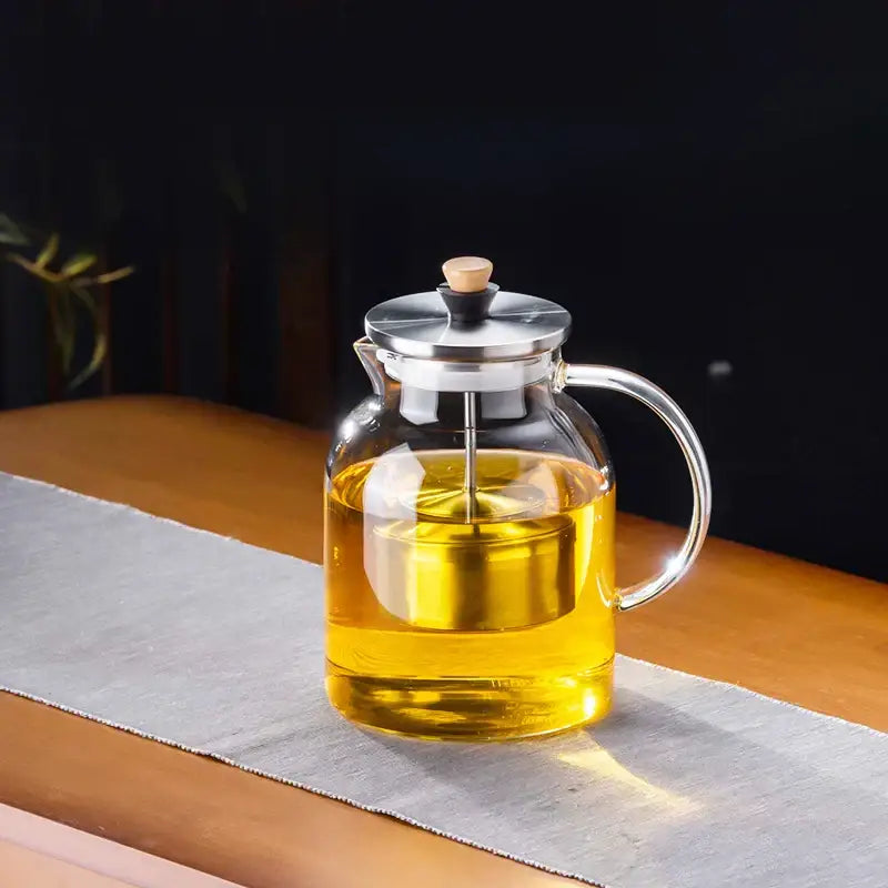 DecorBites glass tea pot with clear glass body, stainless steel lid, wooden handle and knob for herbal tea brewing