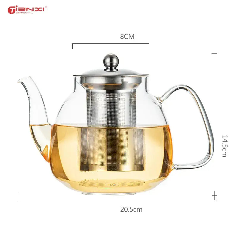 Clear glass tea pot with stainless steel lid and built-in filter containing golden yellow tea for steeping puer coffee and tea