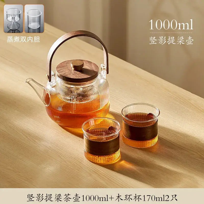 DecorBites glass tea pot with wooden lid and handle and two matching 170ml glass cups steaming in use