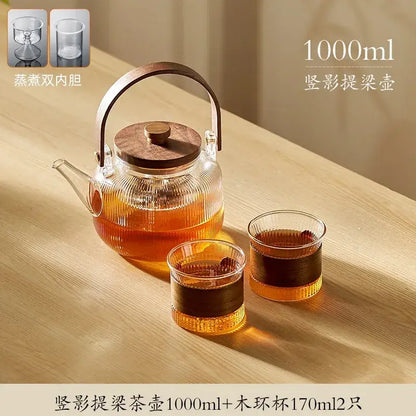 DecorBites glass tea pot with wooden lid and handle and two matching 170ml glass cups steaming in use