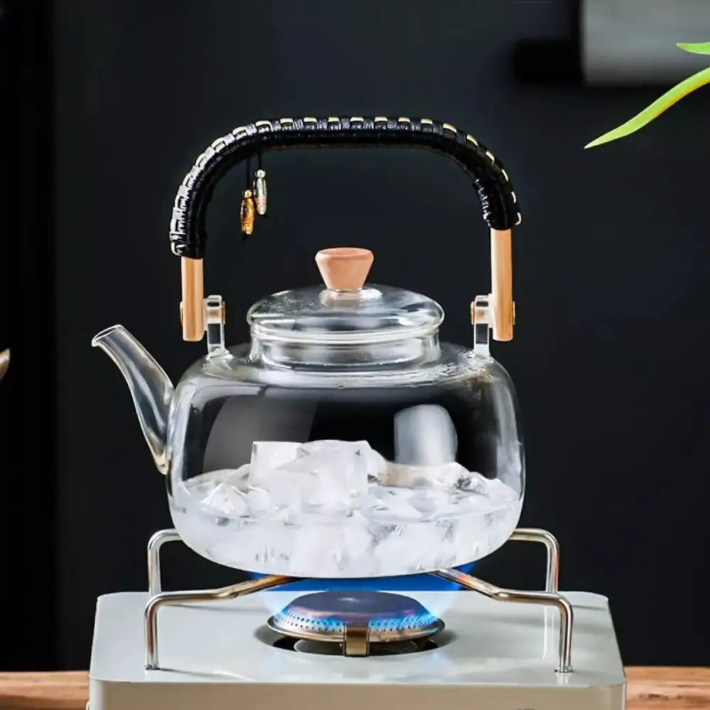Decorbites glass tea pot with clear glass body, black woven wooden handle, and cork lid, 900ml capacity with towel