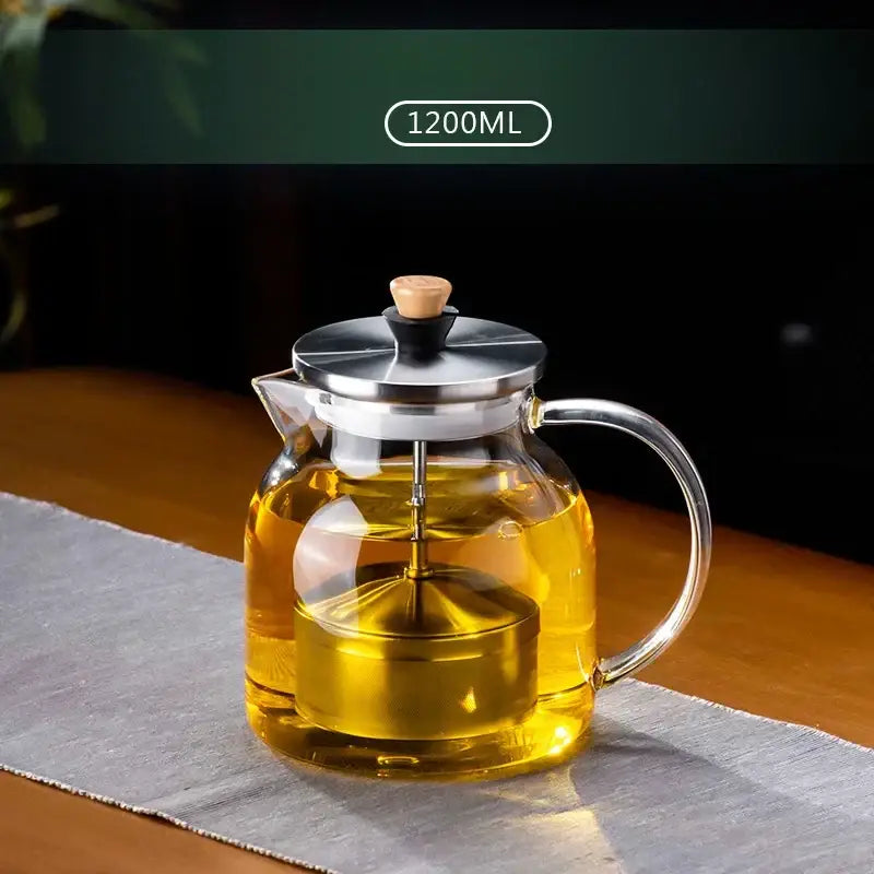 Decorbites glass tea set featuring clear glass teapot with stainless steel lid handle wooden knob and internal infuser