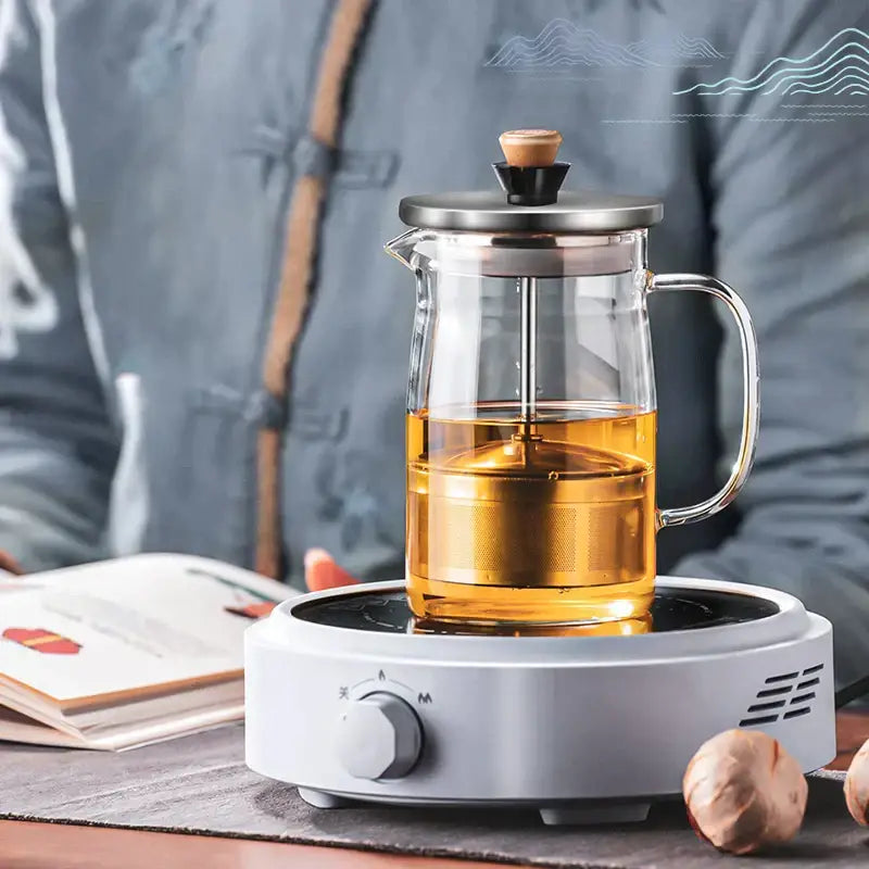 Clear glass tea set by decorbites with stainless steel lid wooden knob filled with golden tea for kung fu style brewing