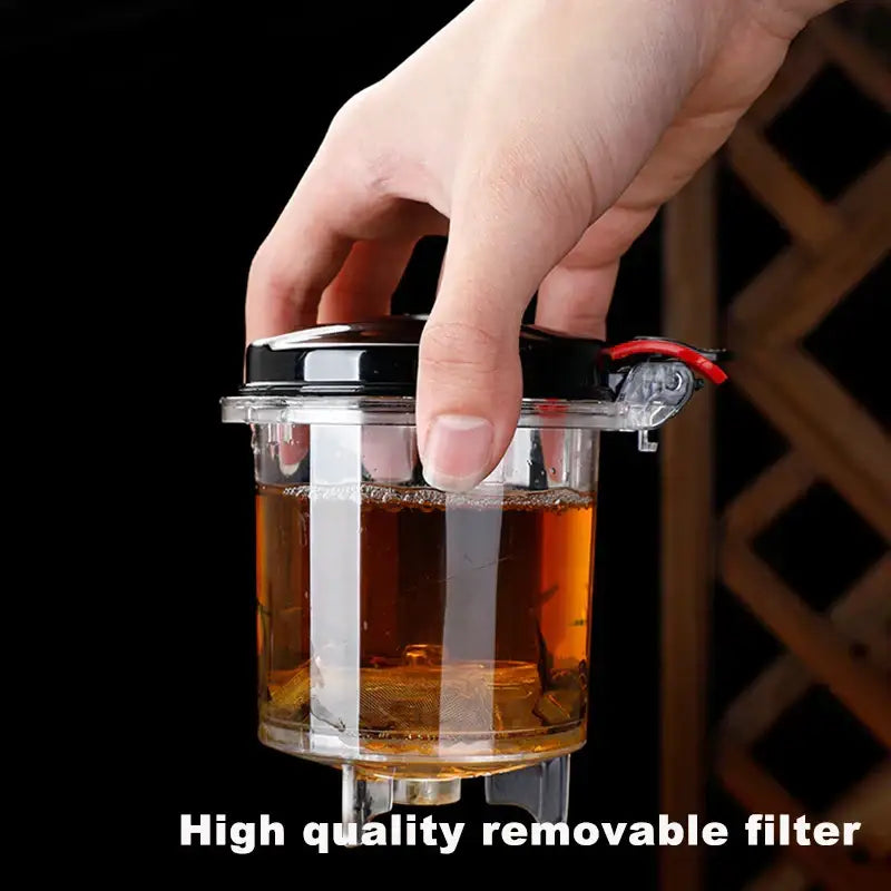 Clear plastic tea infuser with black lid and red lever featuring removable filter in decorbites glass tea set