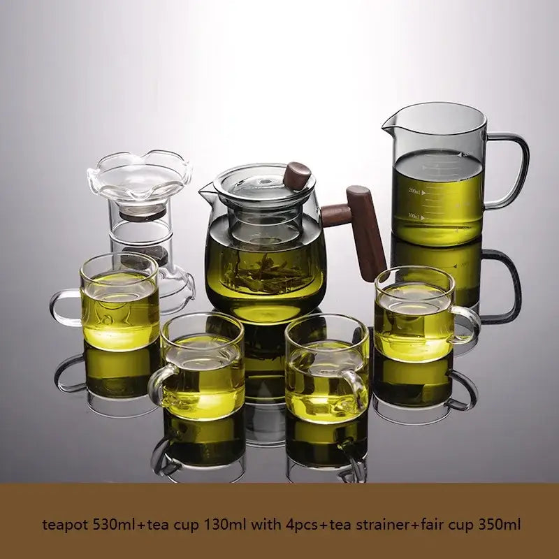 Decorbites glass tea set with clear glass teapot filled with green tea and solid wood handle and lid