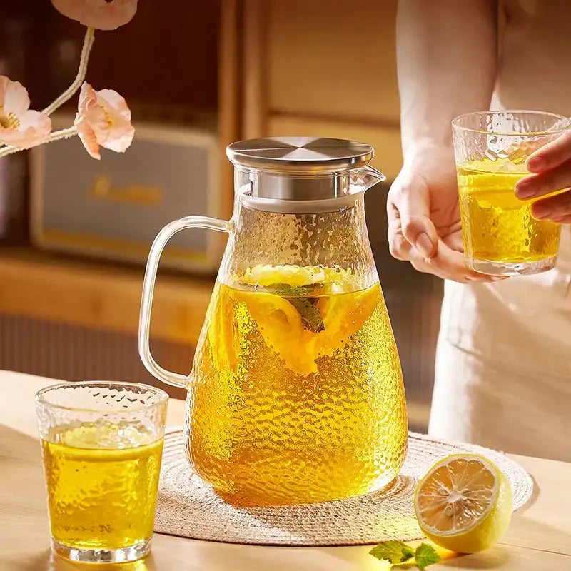 Clear glass pitcher with textured hammered surface and silver lid from decorbites glass tea set for elegant serving