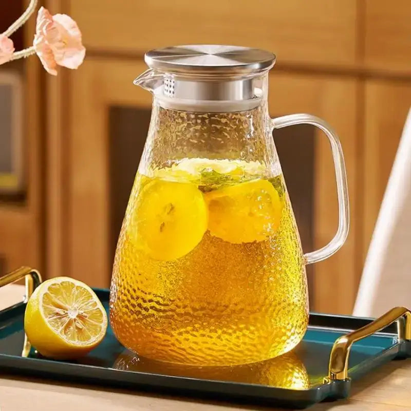 Clear glass pitcher with hammered texture and silver-toned stainless steel lid from decorbites glass tea set