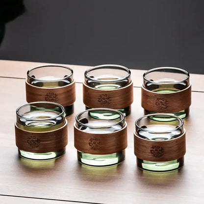 Set of six clear glass tea cups with engraved wooden bands on a retro glass tray from decorbites tea set with wooden handle