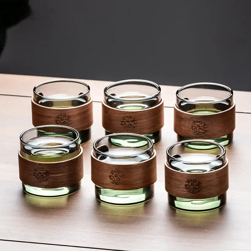 Set of six clear glass tea cups with engraved wooden bands on a retro glass tray from decorbites tea set with wooden handle
