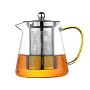Clear glass teapot with gold-toned handle and stainless steel infuser filled with amber tea by decorbites glass teapot