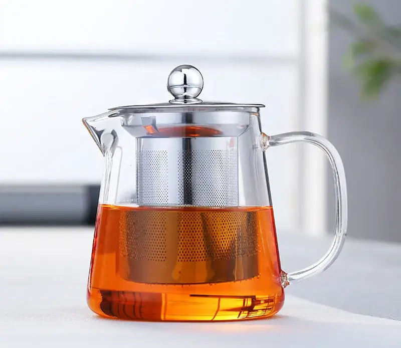 Clear glass teapot with silver infuser and lid knob filled with amber tea by decorbites glass teapot 550ml