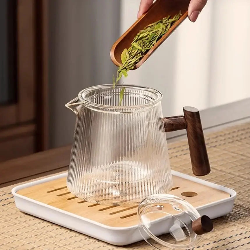Decorbites glass teapot 900ml with vertical ridges and dark wooden handle resting on bamboo tea tray for puer kung fu tea