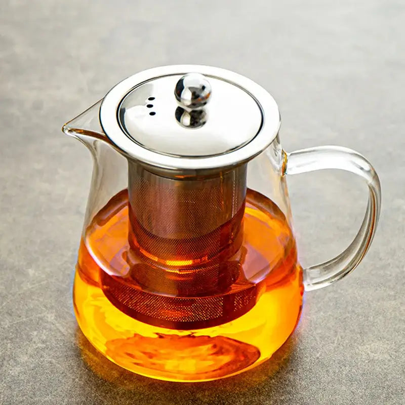 Clear decorbites glass teapot with stainless steel lid and built-in filter holding amber puer tea