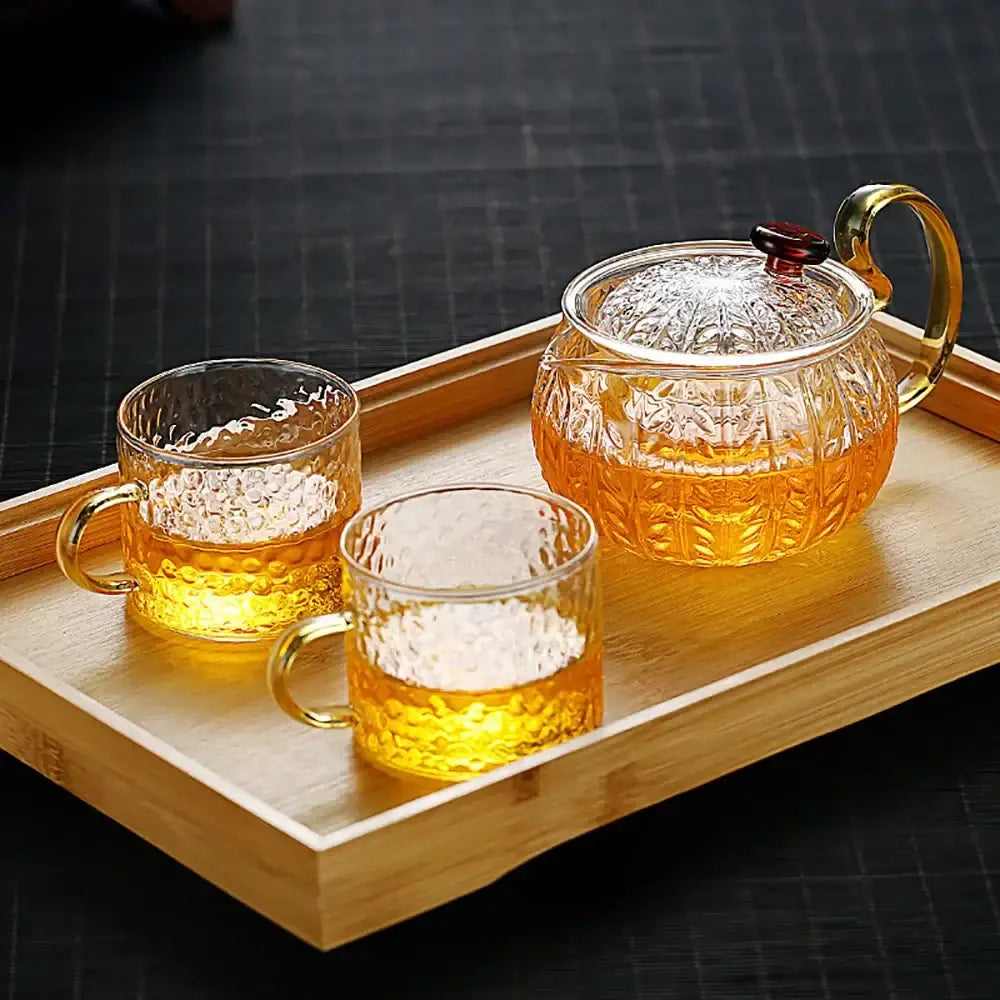 Decorbites glass teapot infuser gaiwan puer with gold-toned handle and two textured glasses on wooden tray