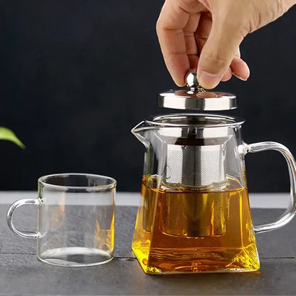 Decorbites glass teapot infuser made of clear glass with stainless steel lid and built-in filter filled with golden tea