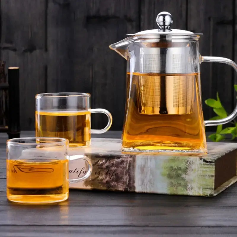 DecorBites glass teapot infuser with stainless steel lid filled with golden tea for kitchen bar home use