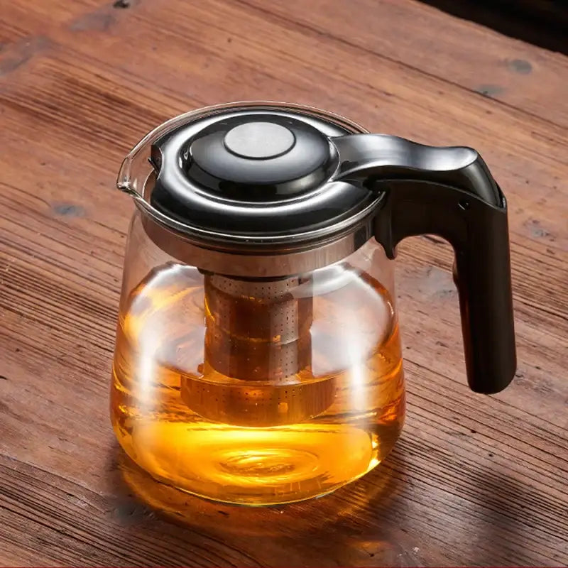 Clear glass teapot with black handle and lid featuring metal infuser by decorbites glass for kung fu tea brewing