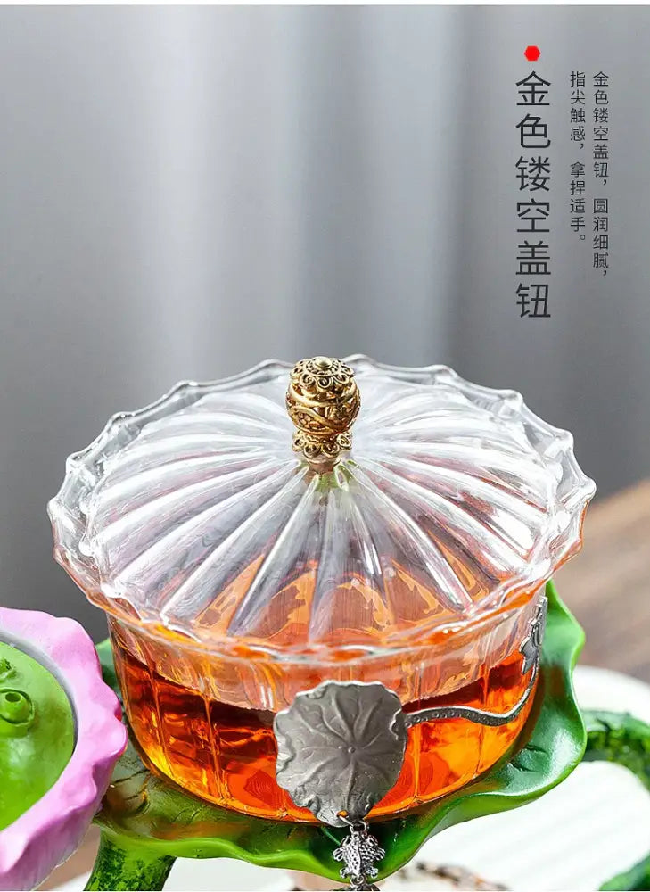 Clear glass DecorBites™ glass teapot with golden ornate lid and silver leaf handle featuring a lazy tea infuser