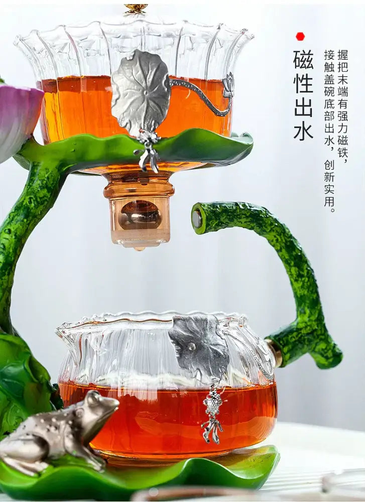 Decorbites glass teapot with green ceramic base and silver leaf accents featuring lazy tea infuser for home use