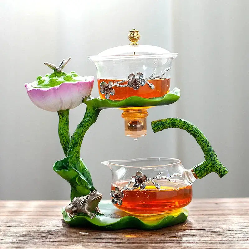 Decorbites glass teapot with lazy tea infuser featuring pink green lotus design and silver floral embellishments