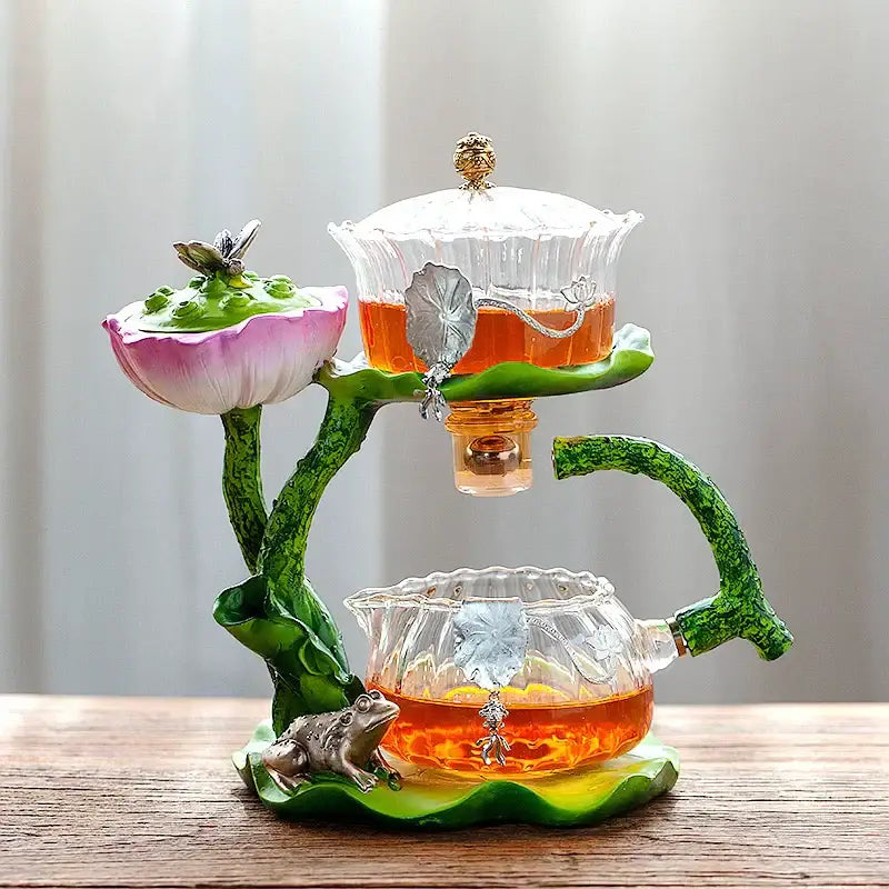 Decorbites glass teapot and lazy tea infuser set with two-tiered lotus design featuring clear glass and green resin stems