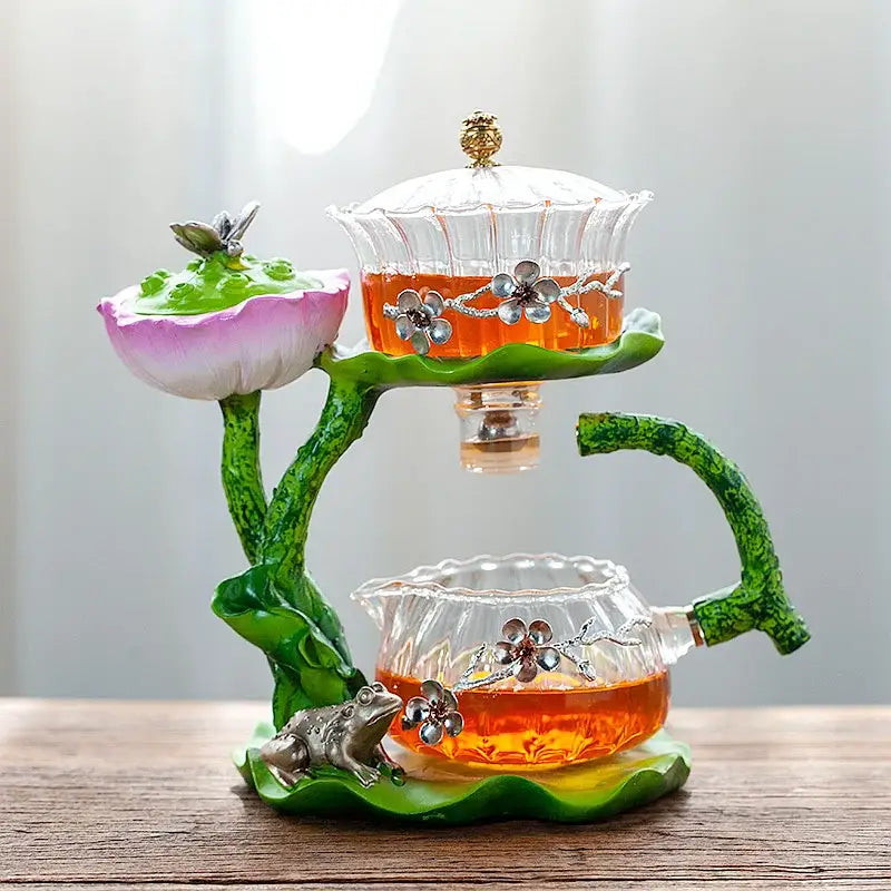 Decorbites glass teapot and lazy tea infuser with a two-tiered glass design and green lotus-themed base and silver accents