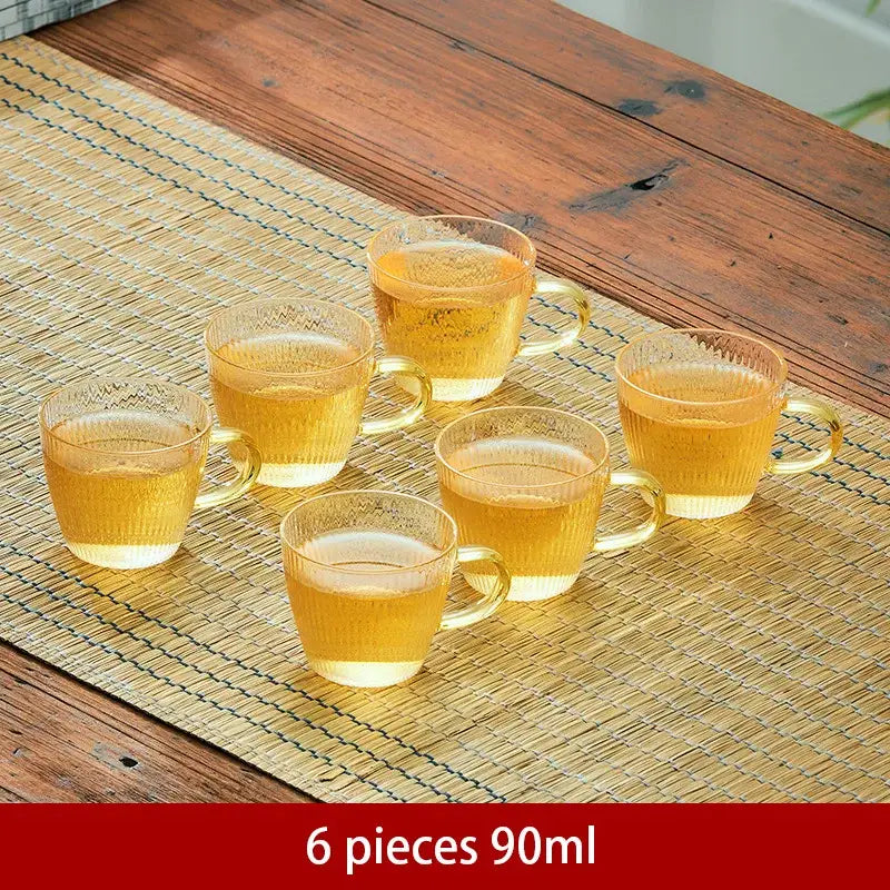 Set of six 90ml transparent ribbed glass tea cups with golden-yellow liquid for decorbites glass teapot puer kettle set