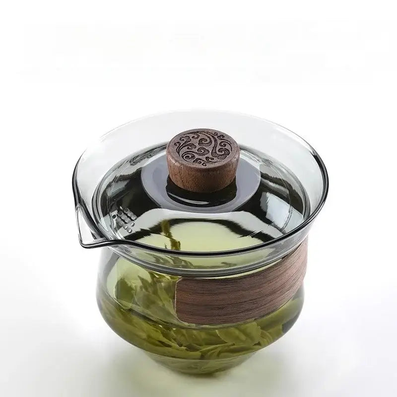 Clear glass teapot set with dark wood lid and handle featuring carved knob in DecorBites glass teapot collection