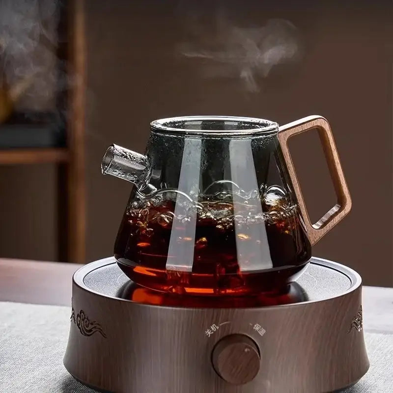 Decorbites™ clear glass teapot set with wooden handle filled with steaming dark tea for kung fu tea and milk rose use