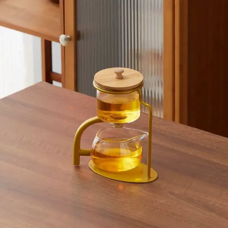 Decorbites glass teapot set with transparent glass infuser, wooden lid, gold frame, and amber brewed tea inside
