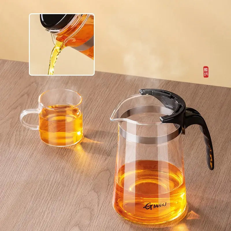 Clear glass decorbites glass teapot with black handle, lid, silver rim, and one-button filter separation feature