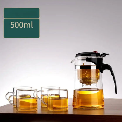 Decorbites glass teapot 500ml clear glass with black handle and lid filled with golden brewed tea and one-button filter separation