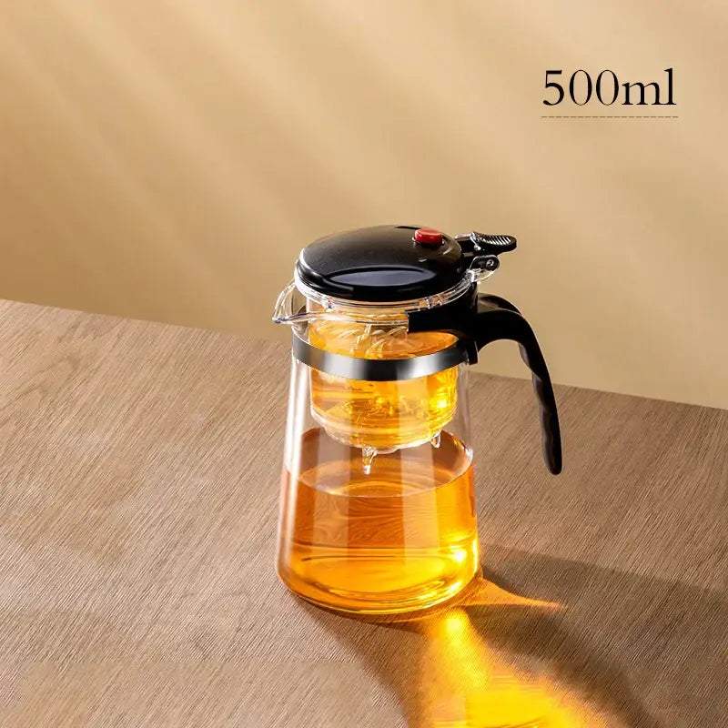 Clear glass DecorBites glass teapot with black lid handle and internal infuser for steeping tea with filter separation